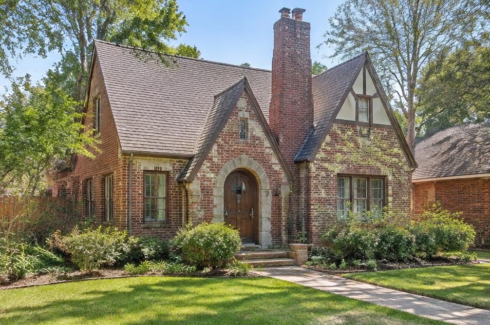 Modest red-brick Tudor cottage with steep roof and traditional windows