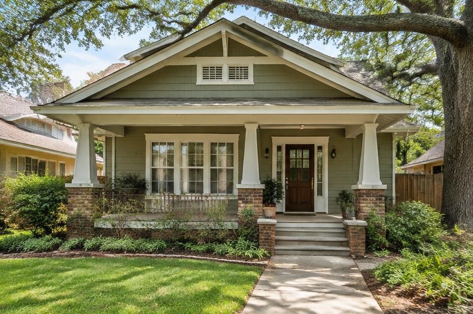 Sage-sided Craftsman bungalow with porch and white-trimmed windows