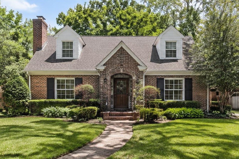 Brick family home with dormer windows and gabled roof