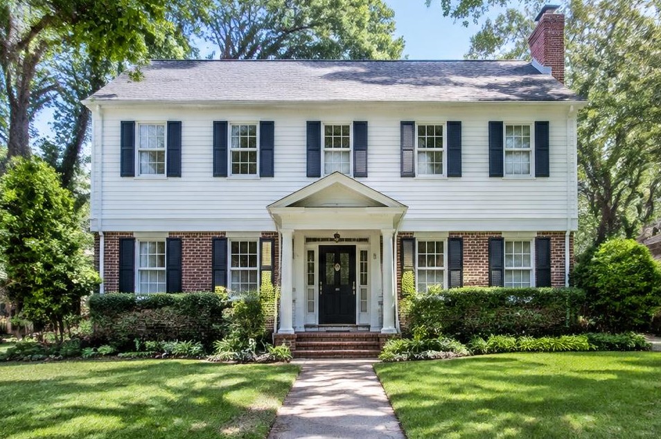 White-sided colonial family home with symmetrical front windows